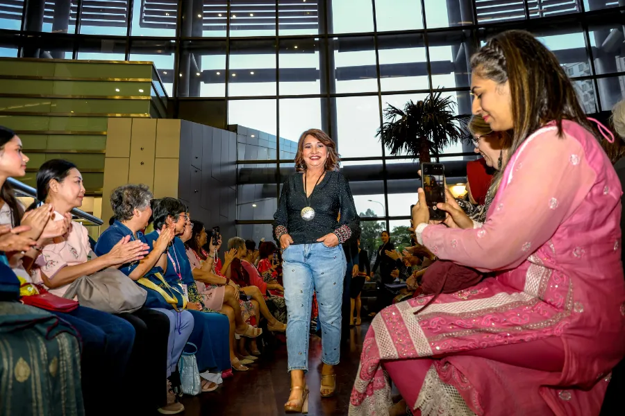 Susan Foong, a 14-year breast cancer survivor, received loud cheers from the crowd when she took the runway.jpg